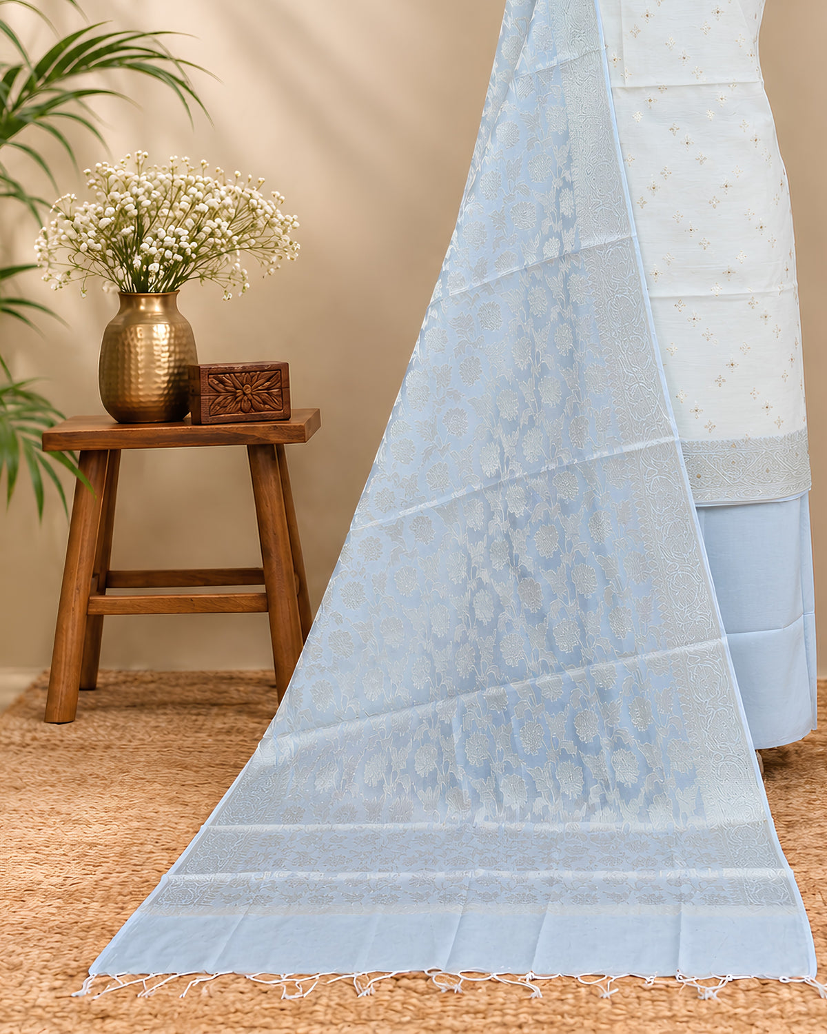 Soft silk cotton fabric in off-white and ice blue from S Fabs, showcasing its smooth texture and pastel color blend.