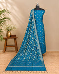 Peacock blue silk butti fabric by S Fabs, showcasing smooth, shiny silk material with intricate weaving details.