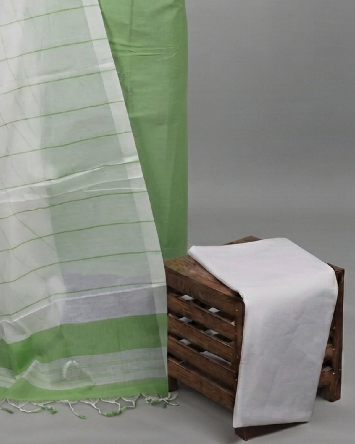 Cotton fabric from S Fabs with green and white leaf stripe pattern, showcasing the Magalagiri material design.