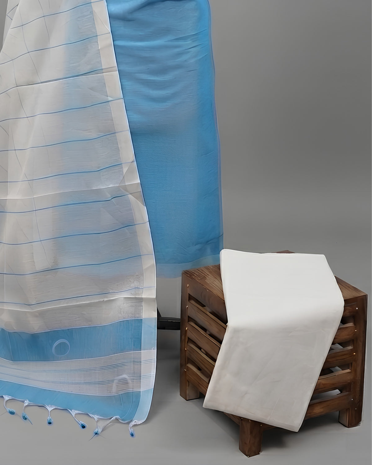 Sky blue and white striped cotton fabric from S Fabs' Magalagiri collection, showcasing soft, lightweight material with a classic pattern.