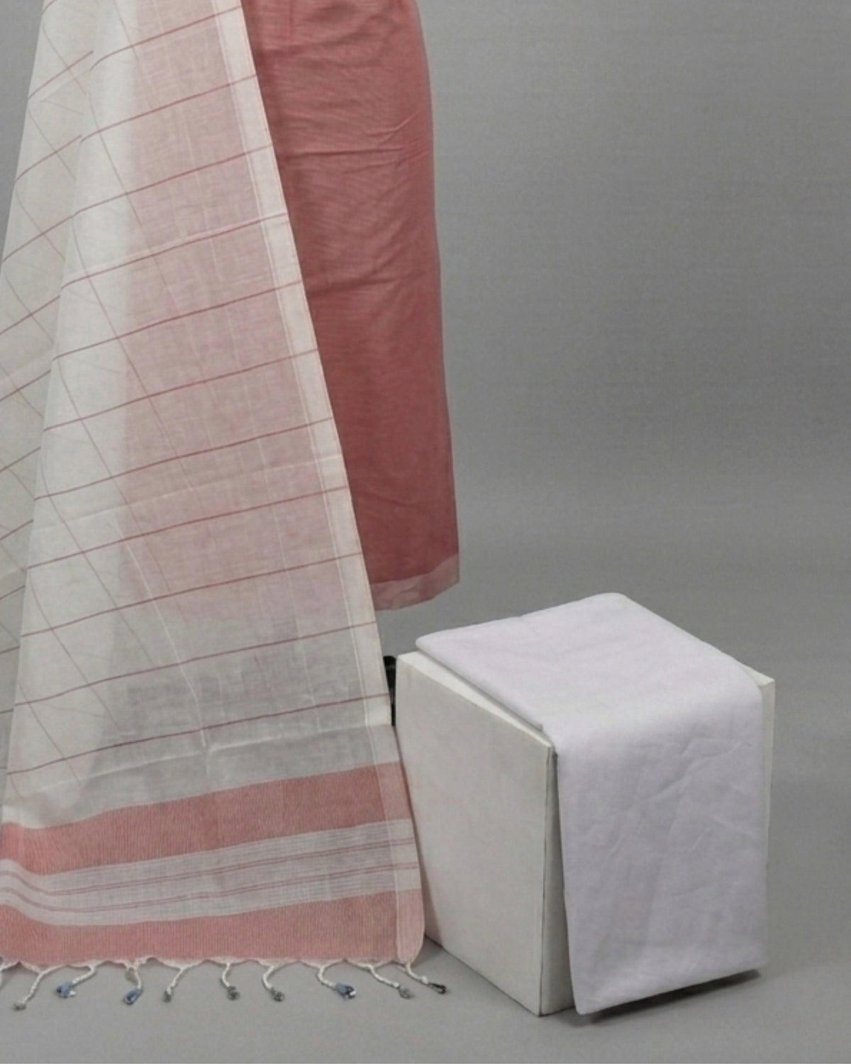 Mangalagiri cotton fabric with dusty rose and white stripes from S Fabs, showcasing soft, woven textile material.